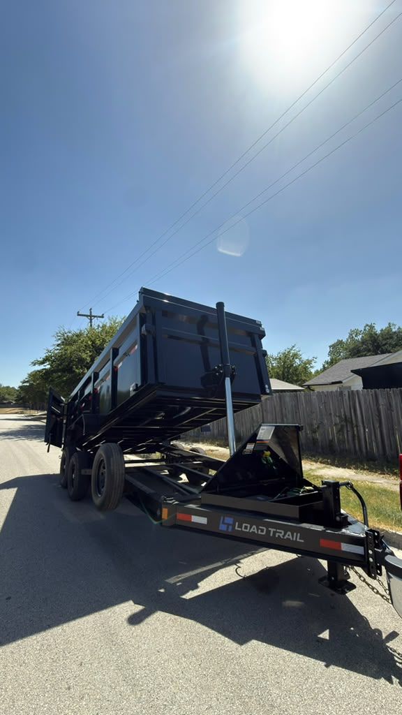 Ford Super Duty towing the LGX dump trailer with the bed raised